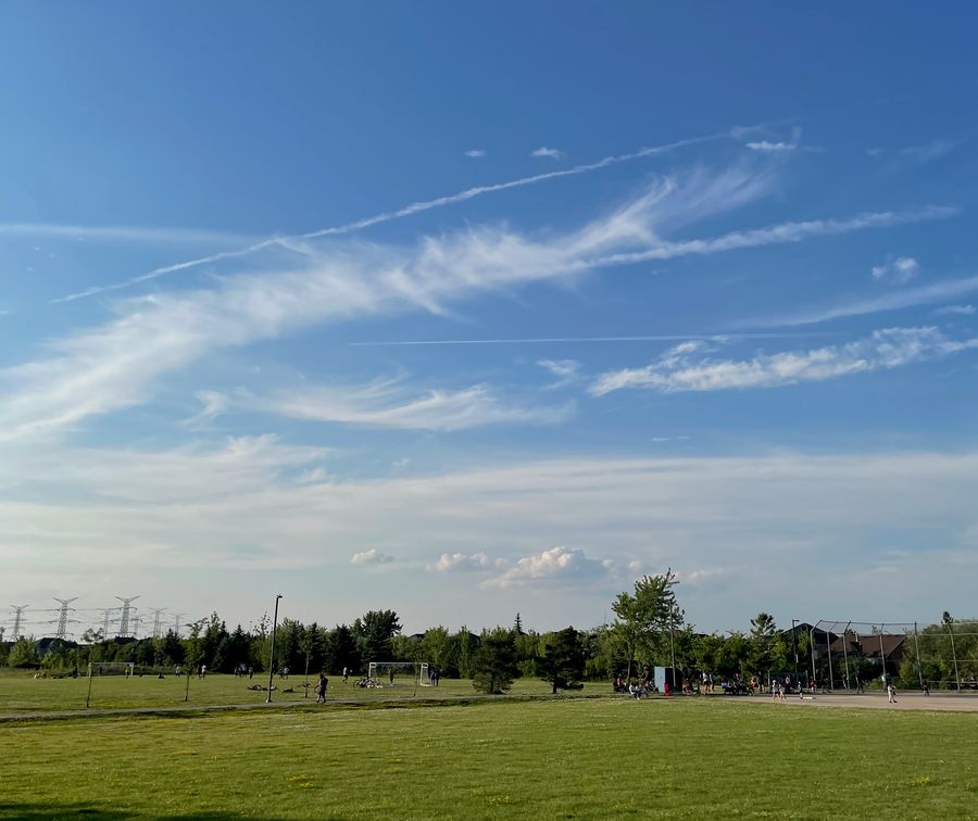 Photo showing a sunny sky and a football field
