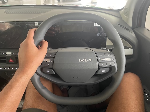 Image showing me with my hands on the Kia Syros steering wheel.