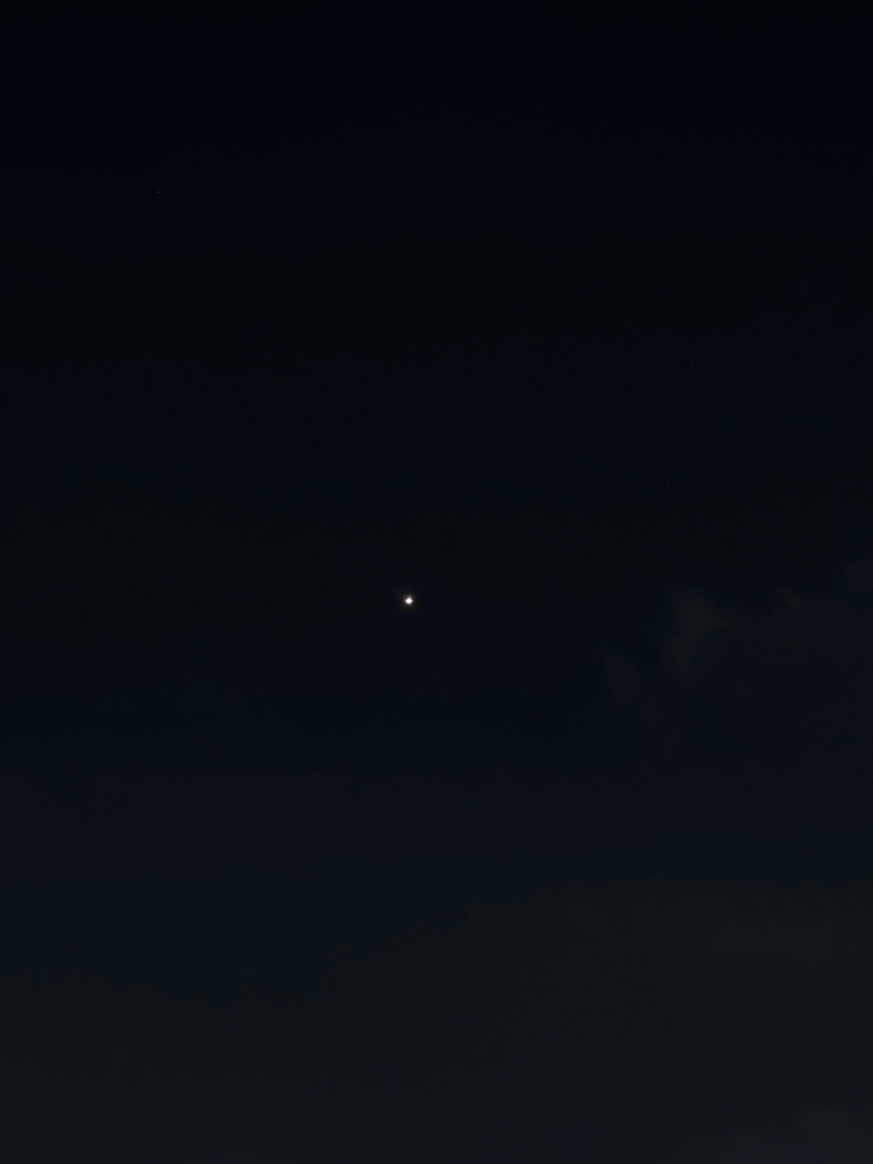 Venus as a single bright pinpoint of light in an almost entirely black night sky.